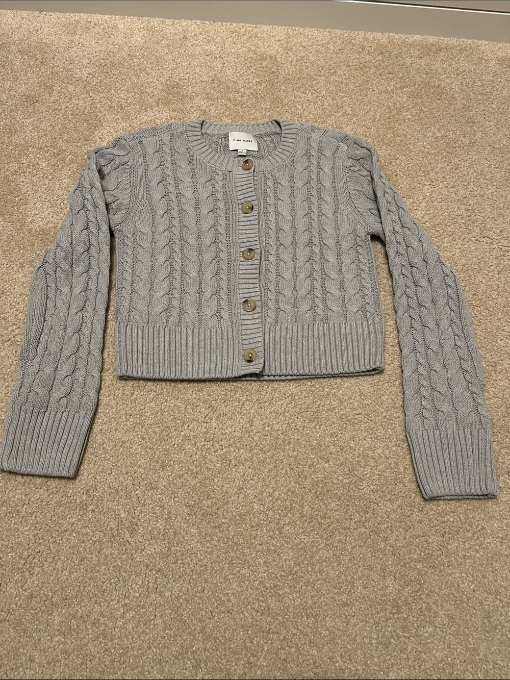 Short cable knit cardigan.